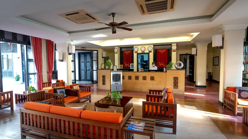 A hotel reception and lounge area with warm lighting