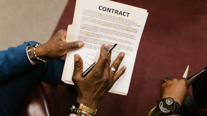 Two people reviewing a contract document