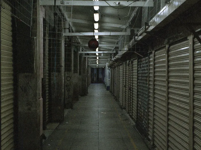 A row of closed shop units with roller shutters